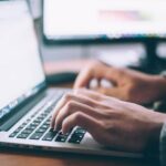 Marketer reviewing campaign results on a laptop